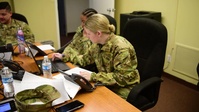 Arkansas National Guard Soldiers answer phone calls about Covid-19