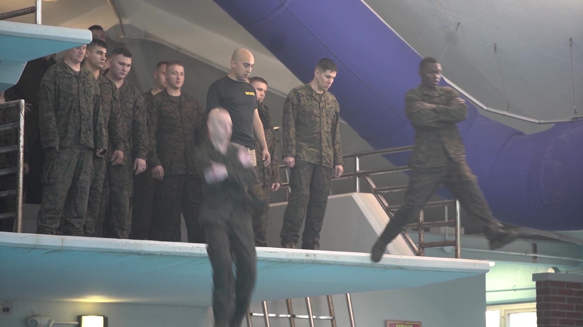 Marines and Sailors with Special Purpose Marine Air-Ground Task Force - Southern Command participate in the basic swim qualification course at Marine Corps Base Camp Lejeune, North Carolina, March 11, 2020. The basic swim qualification course requires Marines to shed a combat load underwater, swim and float in full utilities for 4 minutes, jump from a tower, and swim 25 meters with their pack in order to pass qualification. Marines and Sailors with SPMAGTF-SC are conducting a variety of pre-deployment training events and qualifications prior to deploying in order to enhance crisis response readiness in and around Central America, South America and the Caribbean.