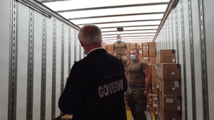 Arkansas National Guardsmen unload trailers of PPE for the state