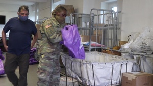 Soldiers assist Post Office workers to get mail to the U.S. Army Garrison Ansbach community.