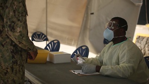 Lab technicians with 3rd Medical Battalion test USS Theodore Roosevelt Sailors for COVID-19