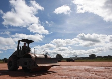 Sailor compacts create a level foundation at the site of the Expeditionary Medical Facility (EMF) being built