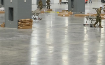 Soldiers assemble hospital equipment to relieve the burden of hospital staff