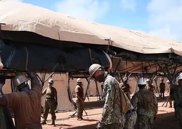 Sailors assigned to Task Force 75.5 assemble a tent during construction of a 150-bed Expeditionary Medical Facility (EMF) onboard Naval Base Guam.