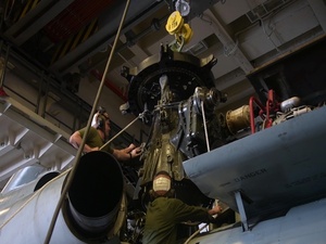 Sailors and Marines Repair Aircraft Engine