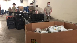Guardsmen packing support assists local food bank
