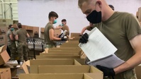 West Virginia National Guardsmen pack meals for the local community through Mountaineer Food Bank