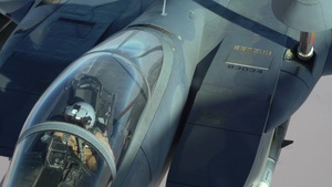 A U.S. Air Force KC-135 Stratotanker refuels F-15E Strike Eagles