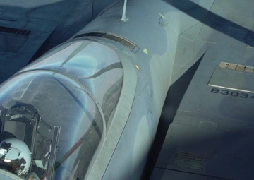 A U.S. Air Force KC-135 Stratotanker refuels F-15E Strike Eagles