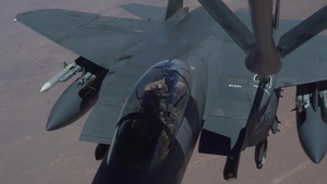 A U.S. Air Force KC-135 Stratotanker refuels F-15E Strike Eagles