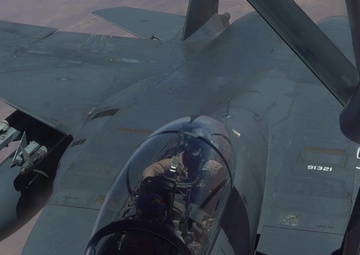 A U.S. Air Force KC-135 Stratotanker refuels F-15E Strike Eagles
