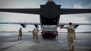 Airmen load a fire apparatus onto a C-130J Super Hercules during exercise Valiant Shield