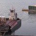 Floating barge with air curtain burner incinerates Lake Cumberland debris
