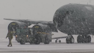 Maintainers move KC-135 in Iowa snow
