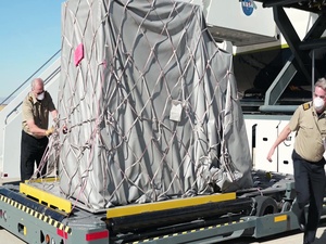 Aircraft carrying supplies for emergency field hospital lands at Plant 42