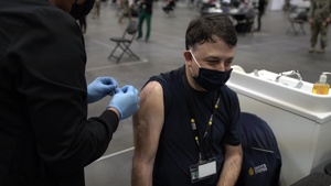 Staff workers at the Javits NY vaccination site receive the vaccine