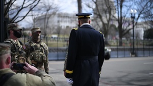 U.S. Army Gen. Daniel R. Hokanson, chief of the National Guard Bureau, hands out coins to members of the National Guard on duty near the U.S. Capitol building