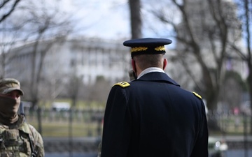 U.S. Army Gen. Daniel R. Hokanson, chief of the National Guard Bureau, hands out coins to members of the National Guard on duty near the U.S. Capitol building