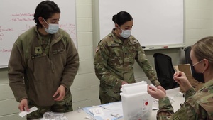 Nebraska National Guard Soldiers and Airmen administer and receive a COVID-19 vaccine