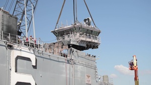 Salvage contractors remove pieces of USS Bonhomme Richard superstructure to ready the ship for towing