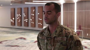U.S. Air Force Senior Airman Luis Cintron speaks about his role at the Ford Field Community Vaccination Center