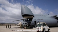 Marines, airmen load helicopters into Super Galaxy for deployment