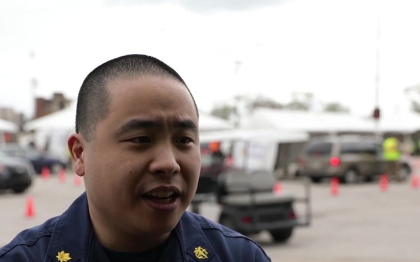 U.S. Public Health Service Lt. Cmdr. Mitchell Chan encourages community members to get vaccinated at the Gary CVC