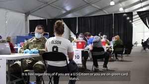A U.S. Service Member speaks to the local Hmong Community St. Paul, Minnesota Community Vaccination Center.