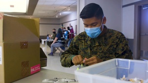 US Navy Hospitalman assembles syringes at Oregon CVC