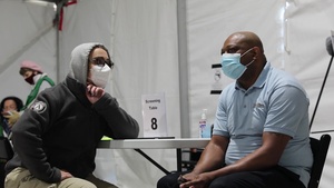 U.S. Air Force medical personnel provides the 50,000th COVID-19 vaccine at Greenbelt