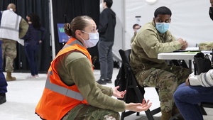 U.S. service members welcome returning community members for their second dose of the COVID-19 vaccine