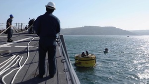 USS Ross Sailors moor to a buoy during FOST