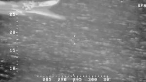 P-3 crew observes go-fast vessel crew jettison bales of contraband into ocean.