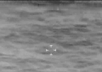 An AMO P-3 observes a “go-fast” smuggling vessel.