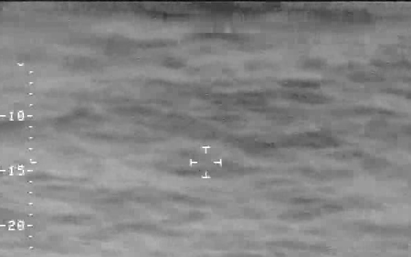 An AMO P-3 observes a “go-fast” smuggling vessel.