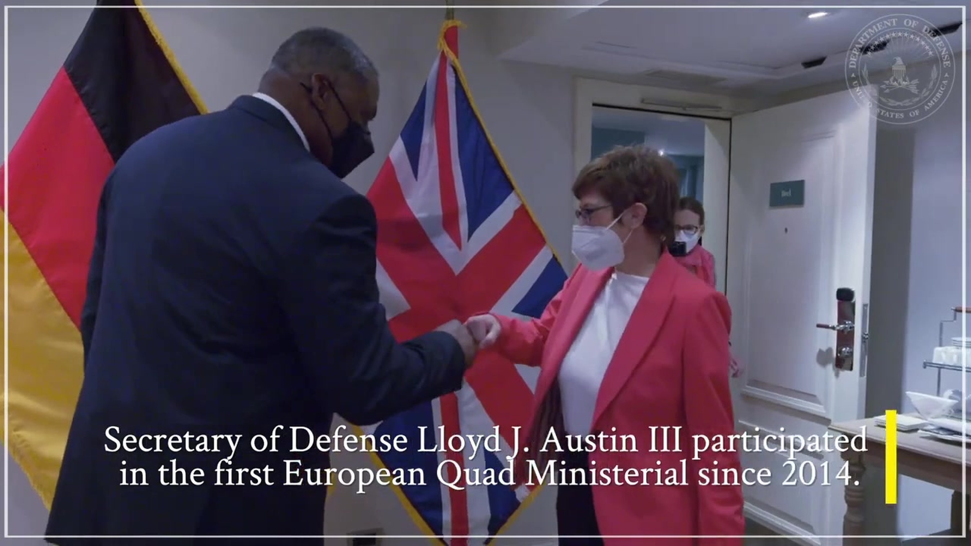 Secretary of Defense Lloyd J. Austin III shakes hands with another official. 