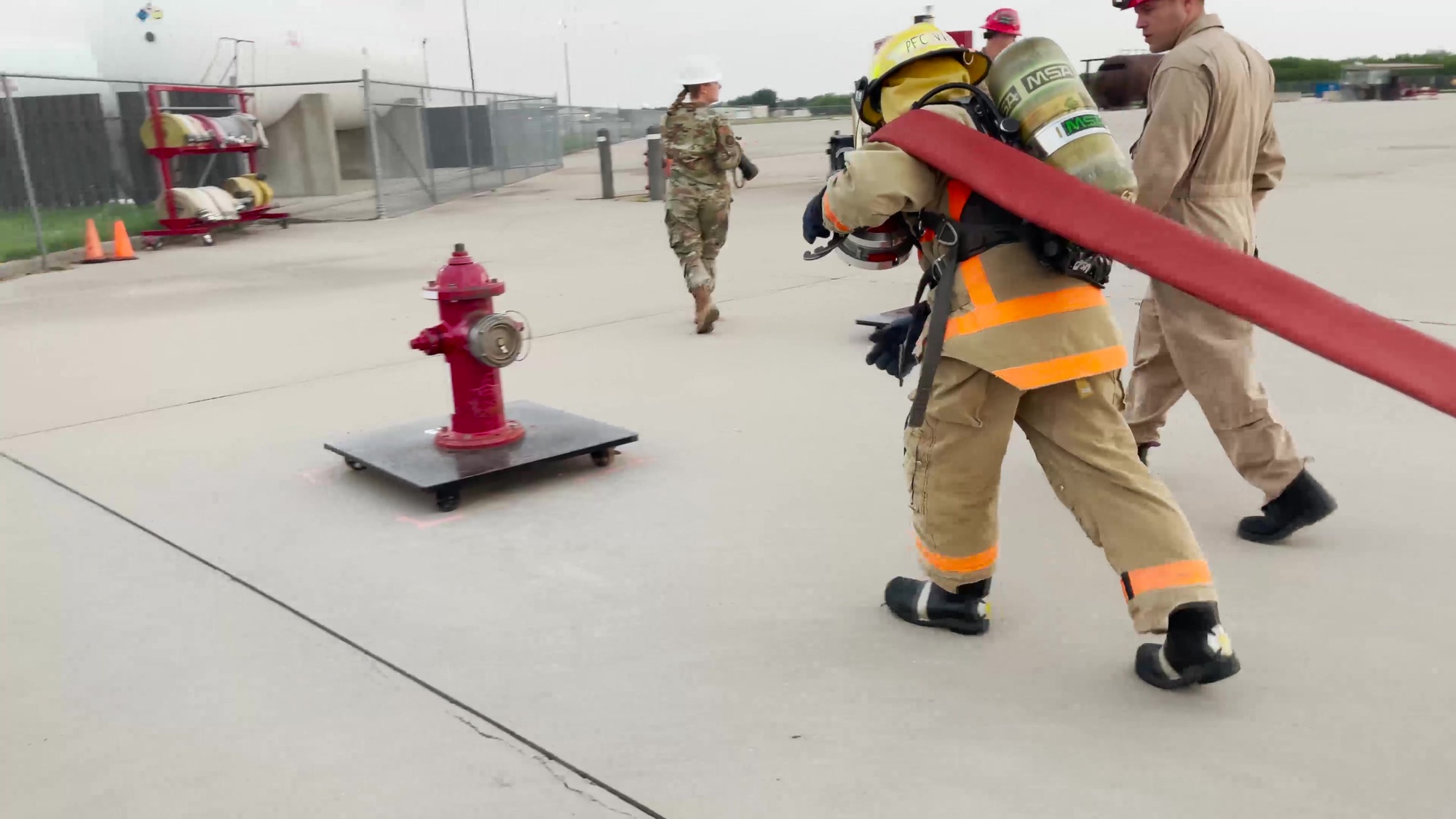 As part of their training, firefighting students assigned to the 312th Training Squadron test their endurance and attention to detail by pulling fire hoses across an area close to the length of a football field!