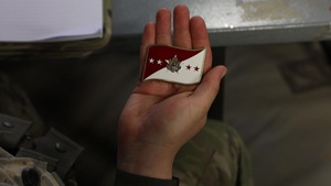 Oklahoma Army National Guard Soldier Pfc. Colton Britt, a fire support specialist in the counter-fire cell at The National Training Center in Fort Irwin, California, received a coin from General James C. McConville, Chief of Staff of the Army