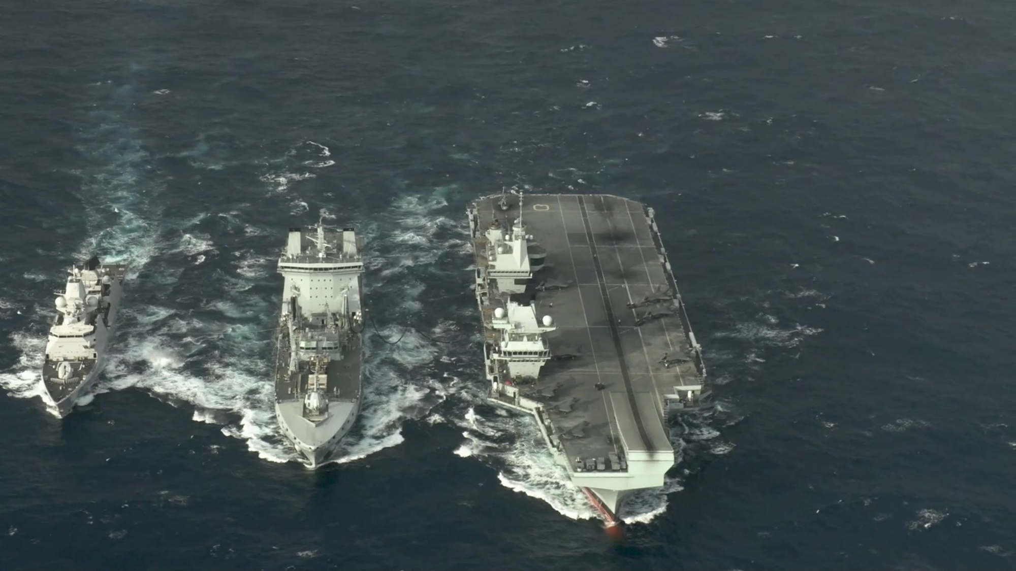 US Marines with Marine Fighter Attack Squadron 211 flying F-35B Lightning II&#39;s conduct routine operations aboard HMS Queen Elizabeth while she conducts a double replenishment with RFA Tidespring and HNLMS Evertsen in the South China Sea on 29 July, 2021.  VMFA-211 is attached to the United Kingdom&#39;s Carrier Strike Group 21, a UK-led international strike group including support from the U.S. Navy Arleigh Burke guided-missile destroyer USS The Sullivans (DDG 68) and The Royal Netherlands Navy HNLMS Evertsen. A free and open Indo-Pacific region that is peaceful and stable is vital to ensuring greater prosperity for the region and the world.