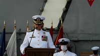 Capt. Walt M. Slaughter and Capt. Amy N. Bauernschmidt read their orders