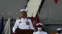 Capt. Walt Slaughter and Capt. Amy Bauernschmidt read their orders