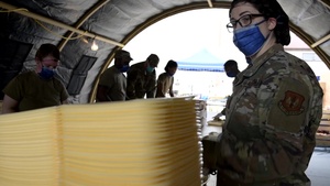 Airmen prepare food for evacuees during Operation Allies Refuge