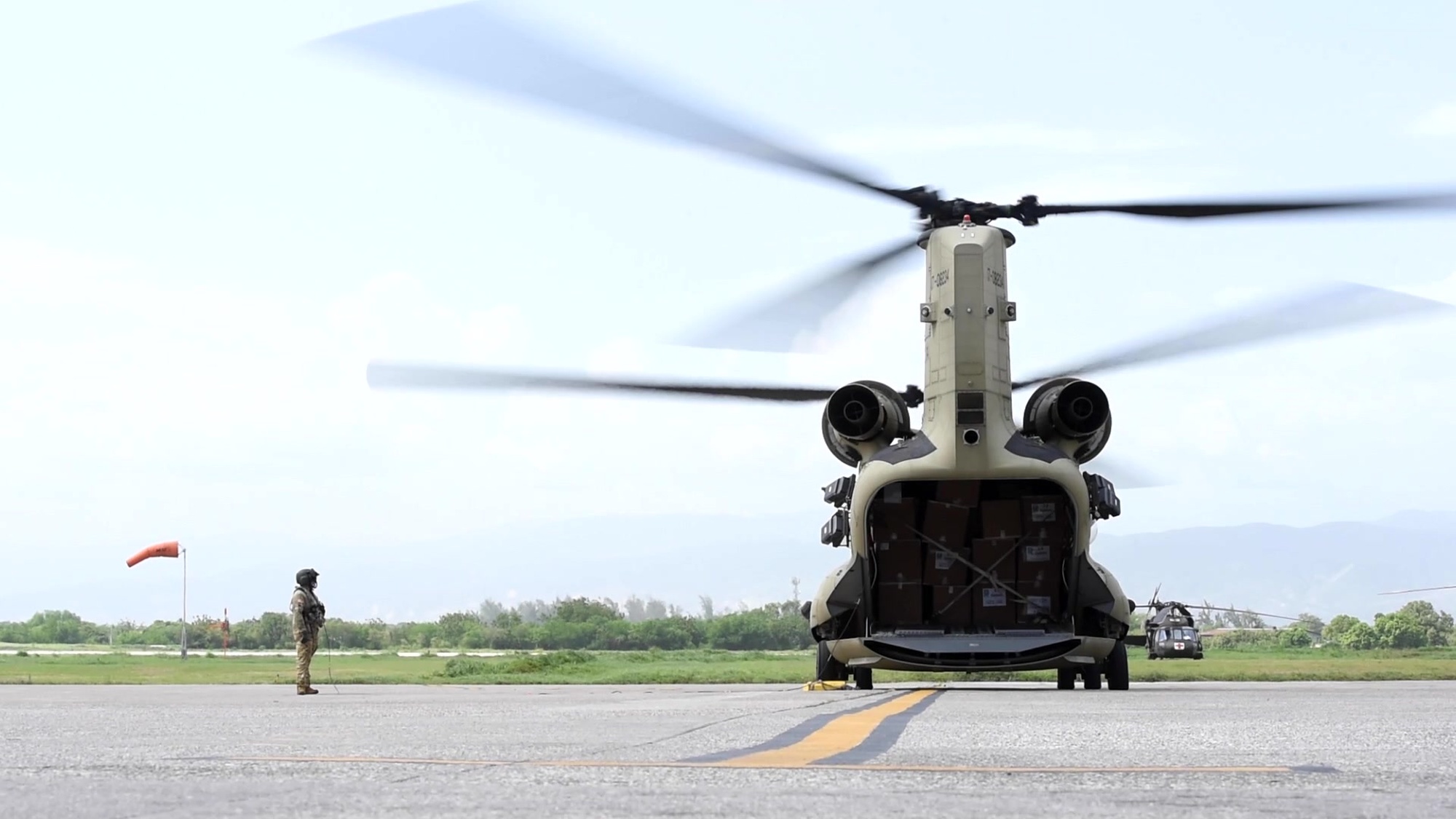 An aircrew with the 1st Battalion, 228th Aviation Regiment, Joint Task Force-Bravo (JTF-B), Soto Cano Air Base, Honduras, prepare to deliver humanitarian aid from Port-au-Prince, Haiti, Aug. 21, 2021. Members of JTF-B support U.S. Agency for International Development (USAID), the lead U.S. federal agency for foreign disaster assistance, by supplying relief efforts to the people of Haiti who were affected by the recent earthquake, Aug. 14. (U.S. Air Force video by Tech. Sgt. Marleah Cabano)