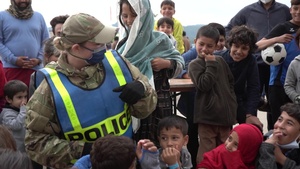 Augmentees and Security Forces personnel interact with Afghan evacuees B-Roll