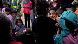 Augmentees and Security Forces interacting with Afghan evacuees