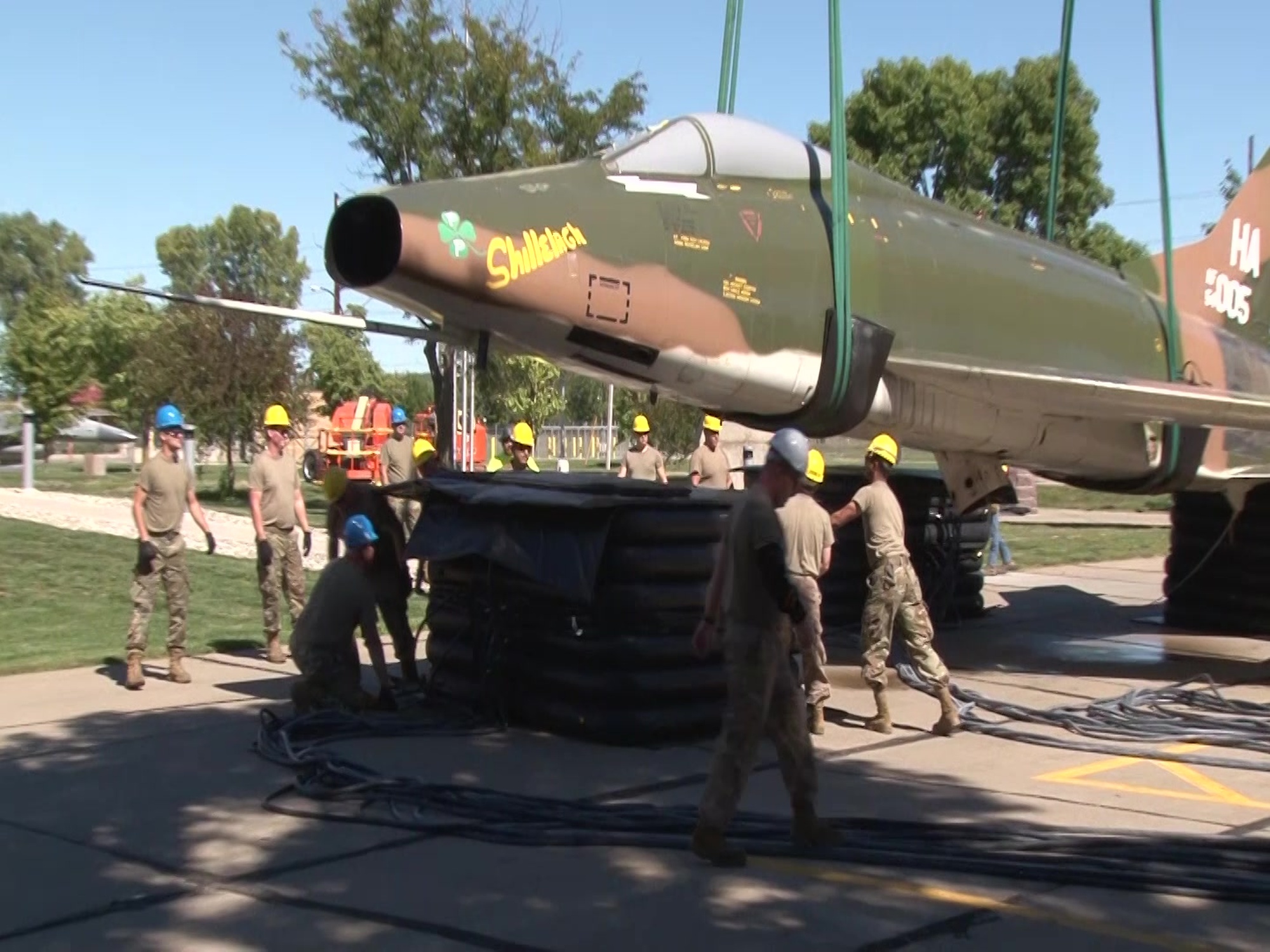 B-roll video shows members of the 185th Air Refueling Wing in Sioux City, Iowa removing a Vietnam War era F-100 Super Sabre from a pedestal mount in order to have the aircraft cleaned and painted. <br /><br />Removing the aircraft allowed members of the unit&#39;s Crash Damage Deposit Recovery or CDDR (see-dar) team to get involved. The CDDR team used module lifting bags that are part of the aircraft crash equipment kit to gently rest the aircraft on the ground.<br /><br />Lowering the 60 year old aircraft on the large pneumatic bags made the job of putting it on the ground safer for the aircraft and safer for the Airmen who were working to recover F-100.