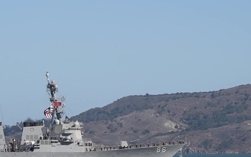 U.S. Navy and Coast Guard ships transit under the Golden Gate Bridge
