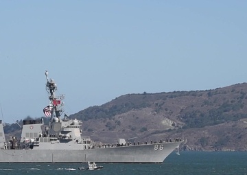 U.S. Navy and Coast Guard ships transit under the Golden Gate Bridge