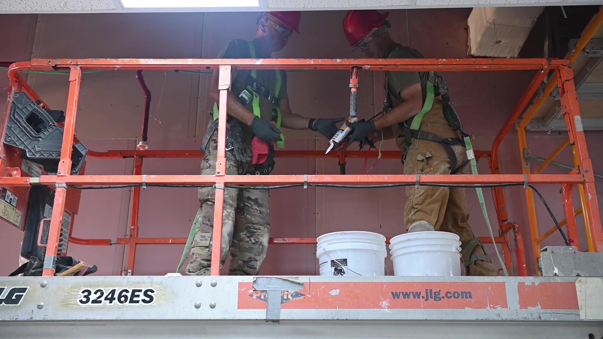 U.S. Air Force 1st Lt. Benjamin Logsdon, 557th Red Horse Squadron director of operations, and Airman 1st Class Naseem Madani, 557th ERHS engineering apprentice, explain how Red Horse accomplish their mission.