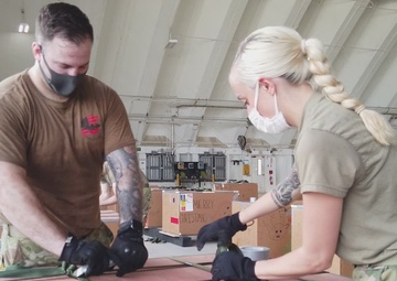 Airmen prepare Operation Christmas Drop bundles